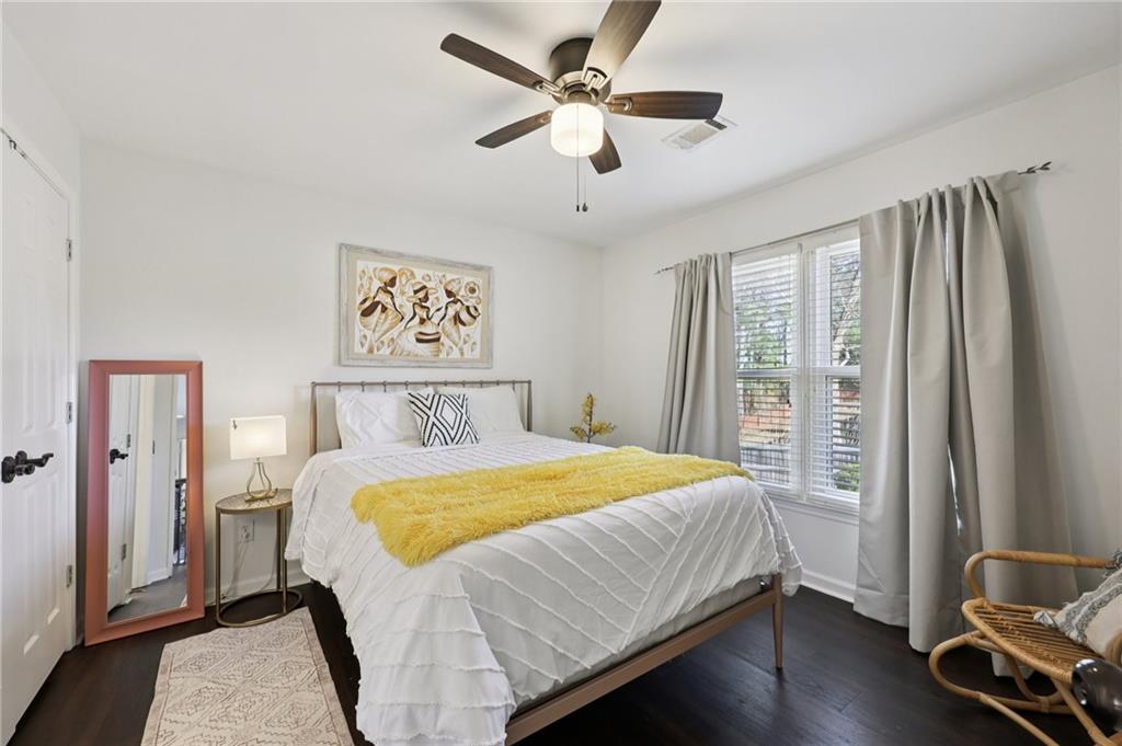 704 Highland Ridge Pointe Lawrenceville, GA 30045 - Photo 25 of 36 a bedroom with a large bed and a chandelier
