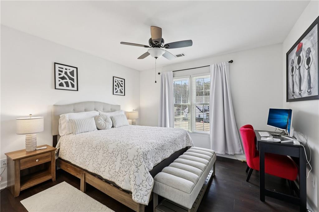 704 Highland Ridge Pointe Lawrenceville, GA 30045 - Photo 26 of 36 a bedroom with a bed and a chandelier