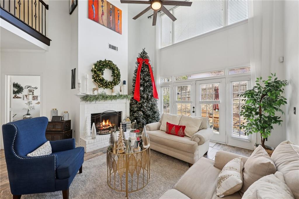 704 Highland Ridge Pointe Lawrenceville, GA 30045 - Photo 5 of 36 a living room with furniture flower pot and a fireplace