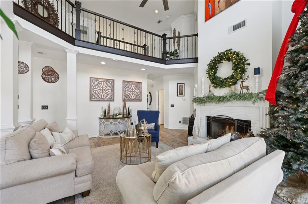 704 Highland Ridge Pointe Lawrenceville, GA 30045 - Photo 7 of 36 a living room with furniture a fireplace and a chandelier