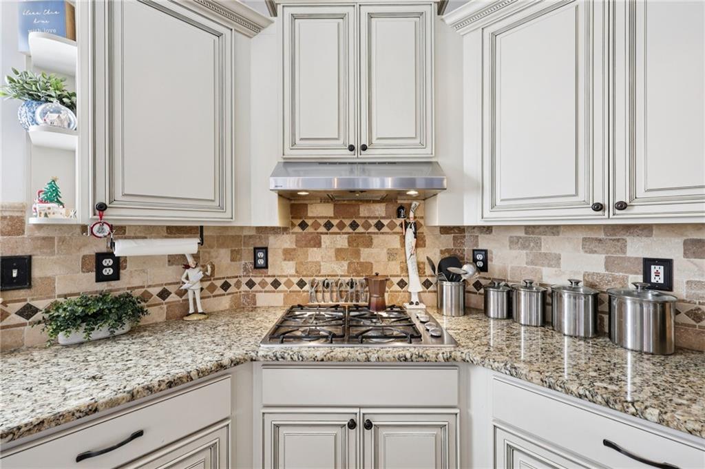 704 Highland Ridge Pointe Lawrenceville, GA 30045 - Photo 10 of 36 a kitchen with granite countertop white cabinets and a stainless steel appliances