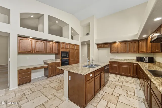 a kitchen with stainless steel appliances granite countertop a sink and cabinets