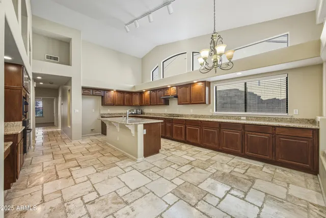 a kitchen with stainless steel appliances a sink and a refrigerator