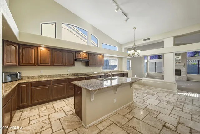 a kitchen with stainless steel appliances granite countertop a sink and cabinets