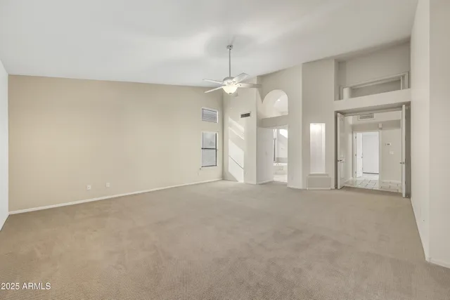 an empty room with a bathroom and a mirror