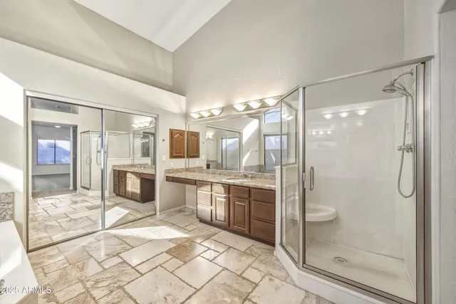 a bathroom with a shower sink and mirror
