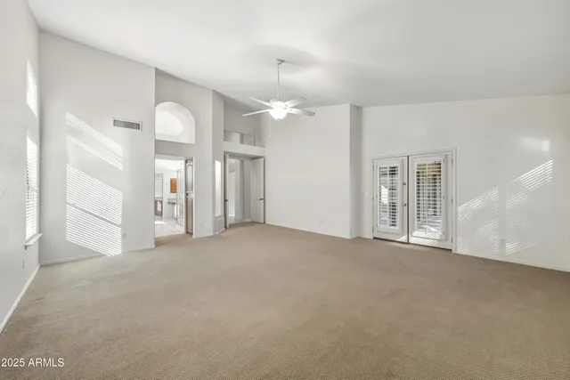 an empty room with windows and entrance