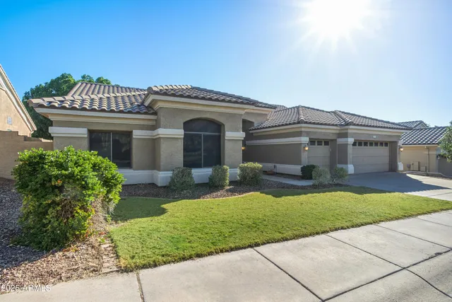 a front view of a house with a garden and plants