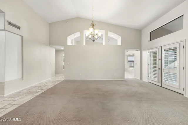 a view of an empty room with chandelier