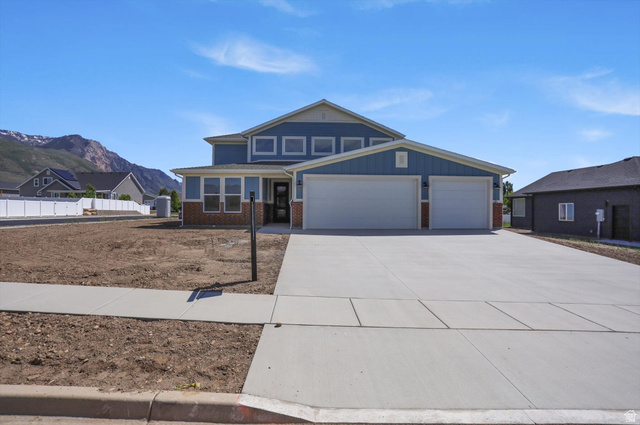 1315 West 3200 South, Unit 17 Perry, UT 84302 - Photo 58 of 58 Contemporary two-story residence featuring a blue siding exterior with brick accents