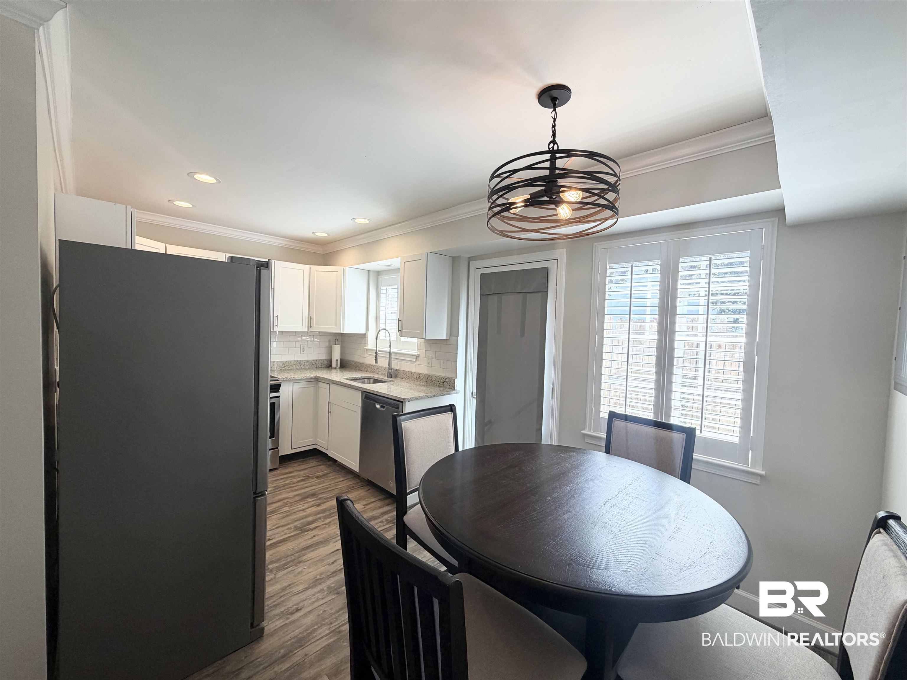 100 Du Rhu Drive, Unit J Mobile, AL 36608 - Photo 4 of 17 Dining room with dark wood finished floors, crown molding, and a chandelier