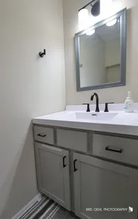 a bathroom with a sink and a mirror