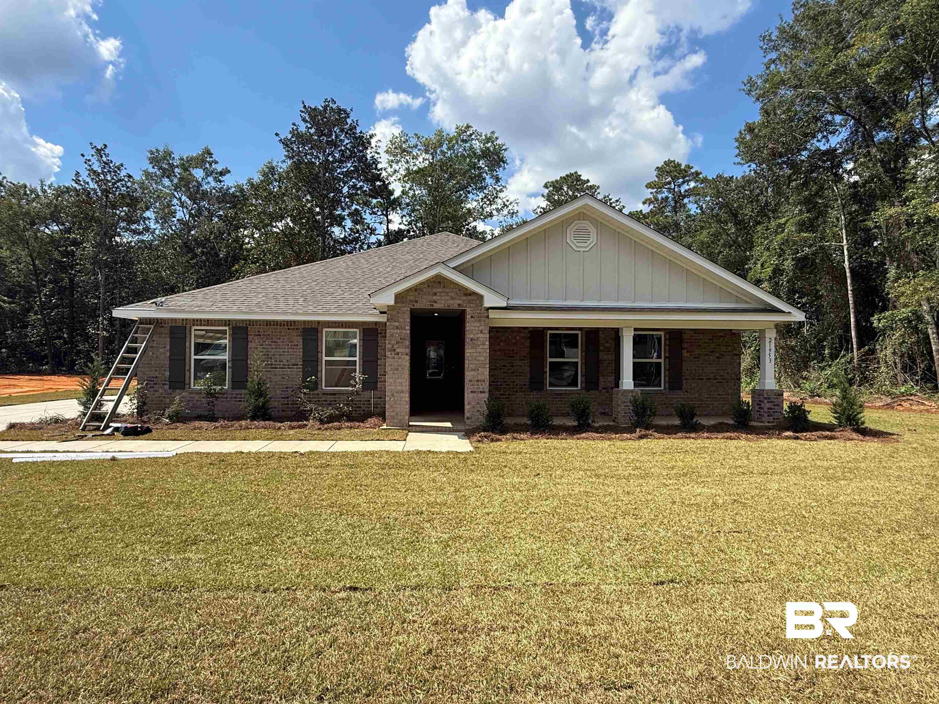 21953 Sedlack Road Silverhill, AL 36576 - Photo 1 of 28 View of front of home featuring a front yard, covered porch, and brick siding