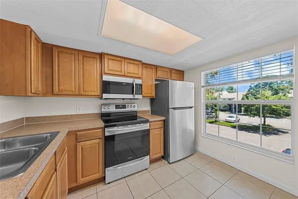 a kitchen with a refrigerator sink and microwave