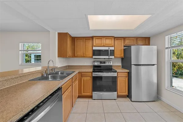 a kitchen with a refrigerator sink and cabinets