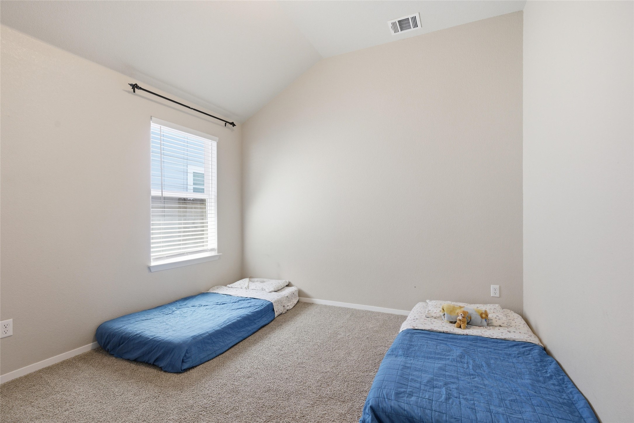269 Gaida Loop Georgetown, TX 78628 - Photo 15 of 20 Carpeted bedroom featuring lofted ceiling and baseboards