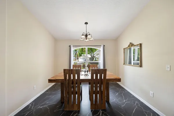 a view of a dining room with furniture window and outside view