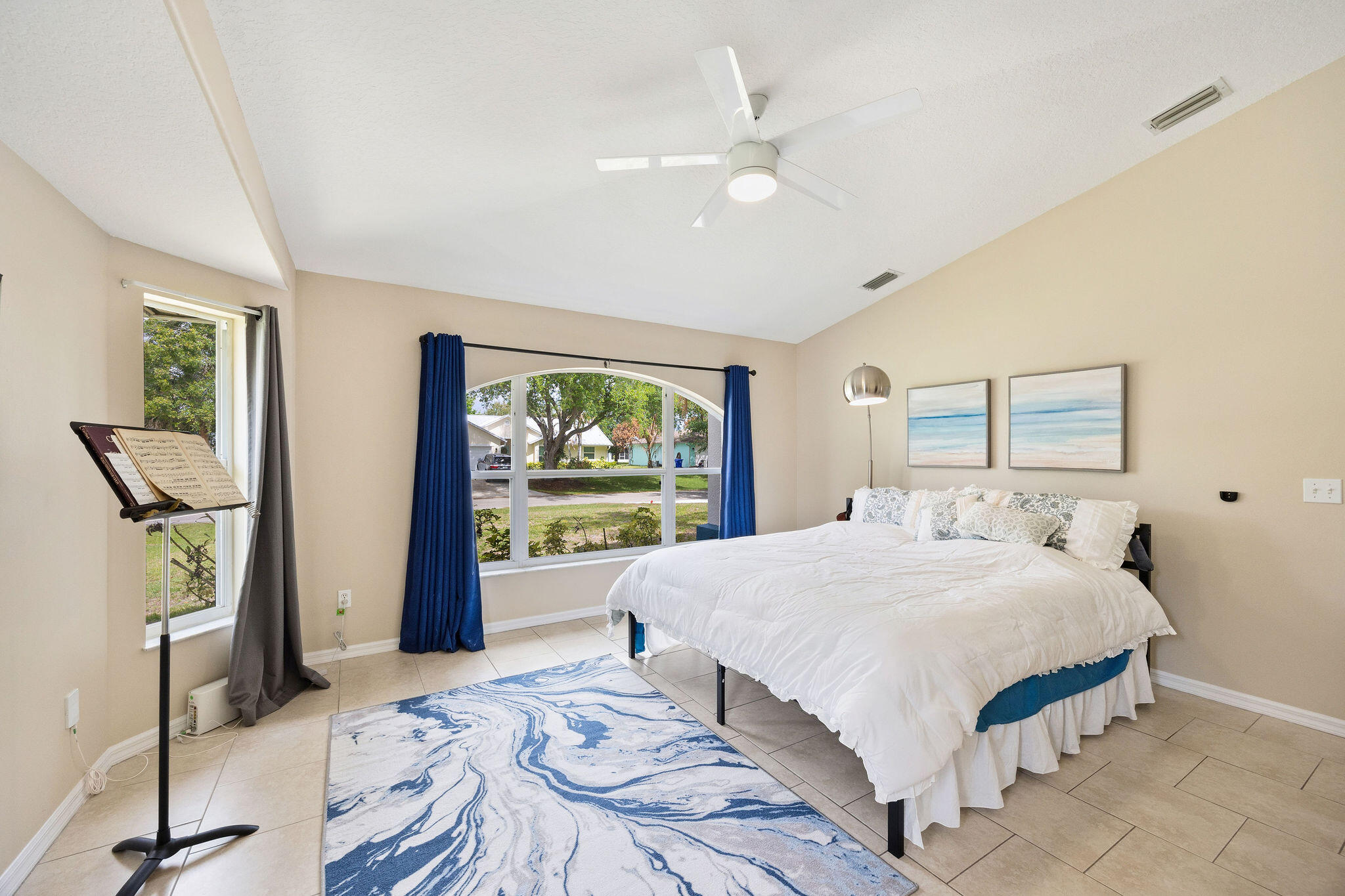 720 Bayfront Terrace Sebastian, FL 32958 - Photo 16 of 33 a bedroom with a bed and a flat screen tv