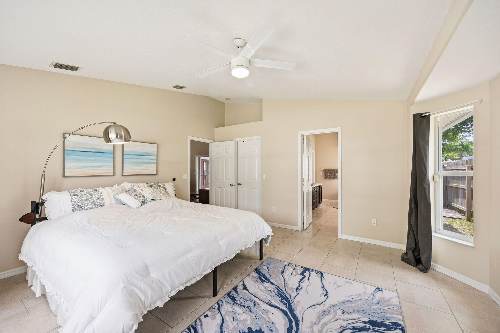 720 Bayfront Terrace Sebastian, FL 32958 - Photo 17 of 33 a bedroom with a large bed and a chandelier
