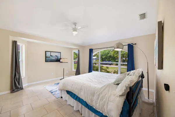 a bedroom with a large bed and a window