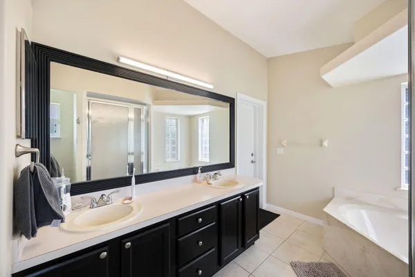 a bathroom with a double vanity sink mirror and double