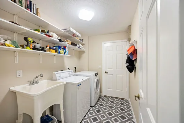 a utility room with a sink dryer and washer