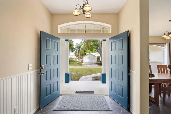a view of a hallway with windows and dining room