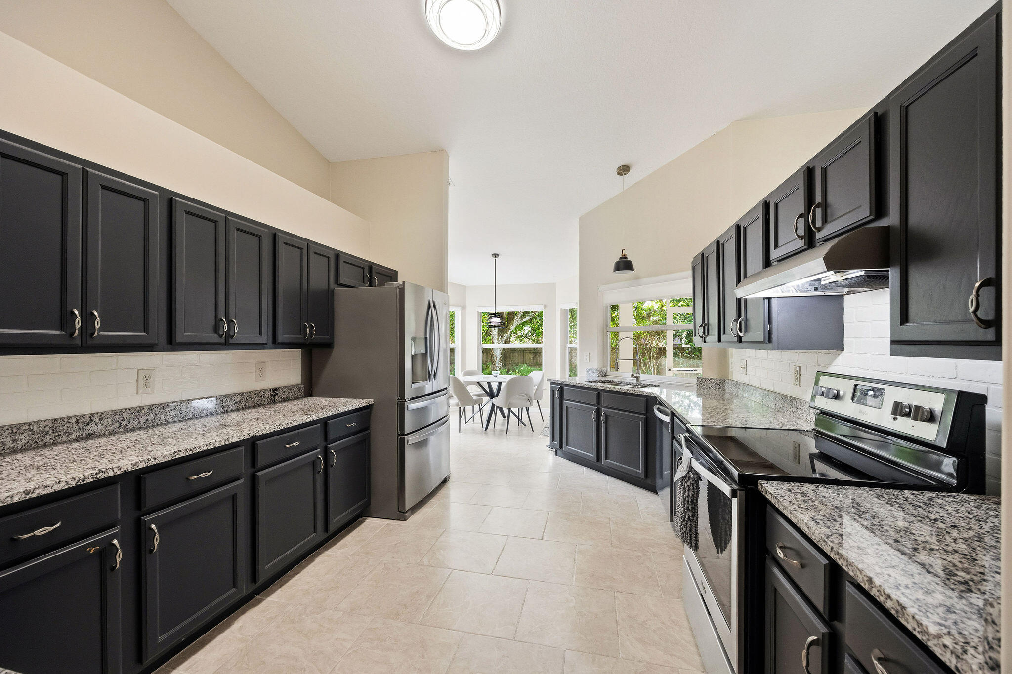 720 Bayfront Terrace Sebastian, FL 32958 - Photo 6 of 33 a kitchen with stainless steel appliances granite countertop a stove and a sink