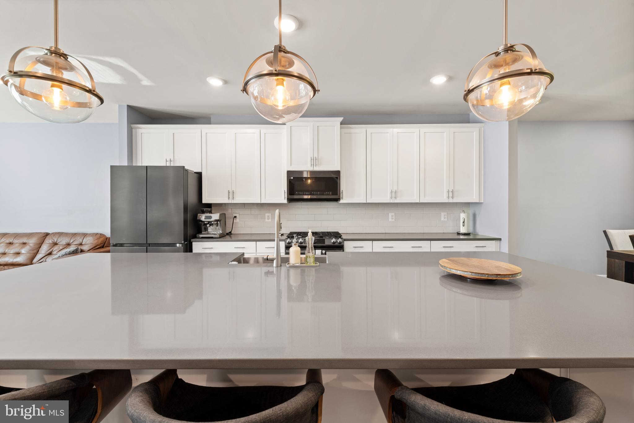 135 Klee Alley Silver Spring, MD 20906 - Photo 14 of 37 a kitchen with stainless steel appliances granite countertop a sink refrigerator stove and microwave