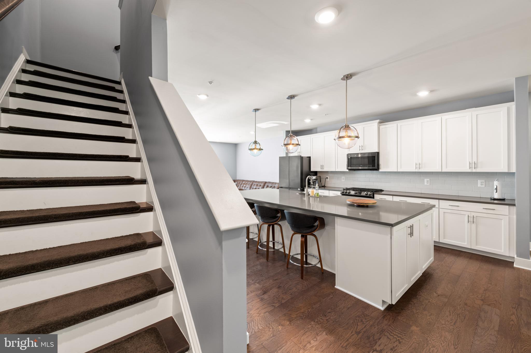 135 Klee Alley Silver Spring, MD 20906 - Photo 23 of 37 a kitchen with a sink a stove a microwave and cabinets