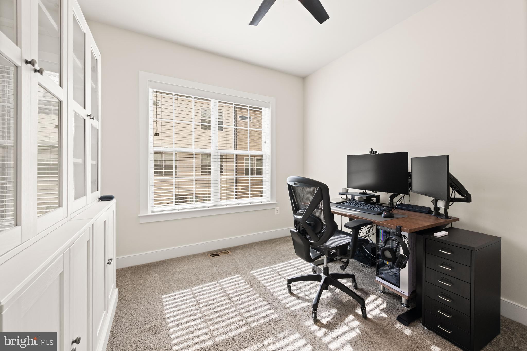 135 Klee Alley Silver Spring, MD 20906 - Photo 26 of 37 a view of a workspace with furniture and a window