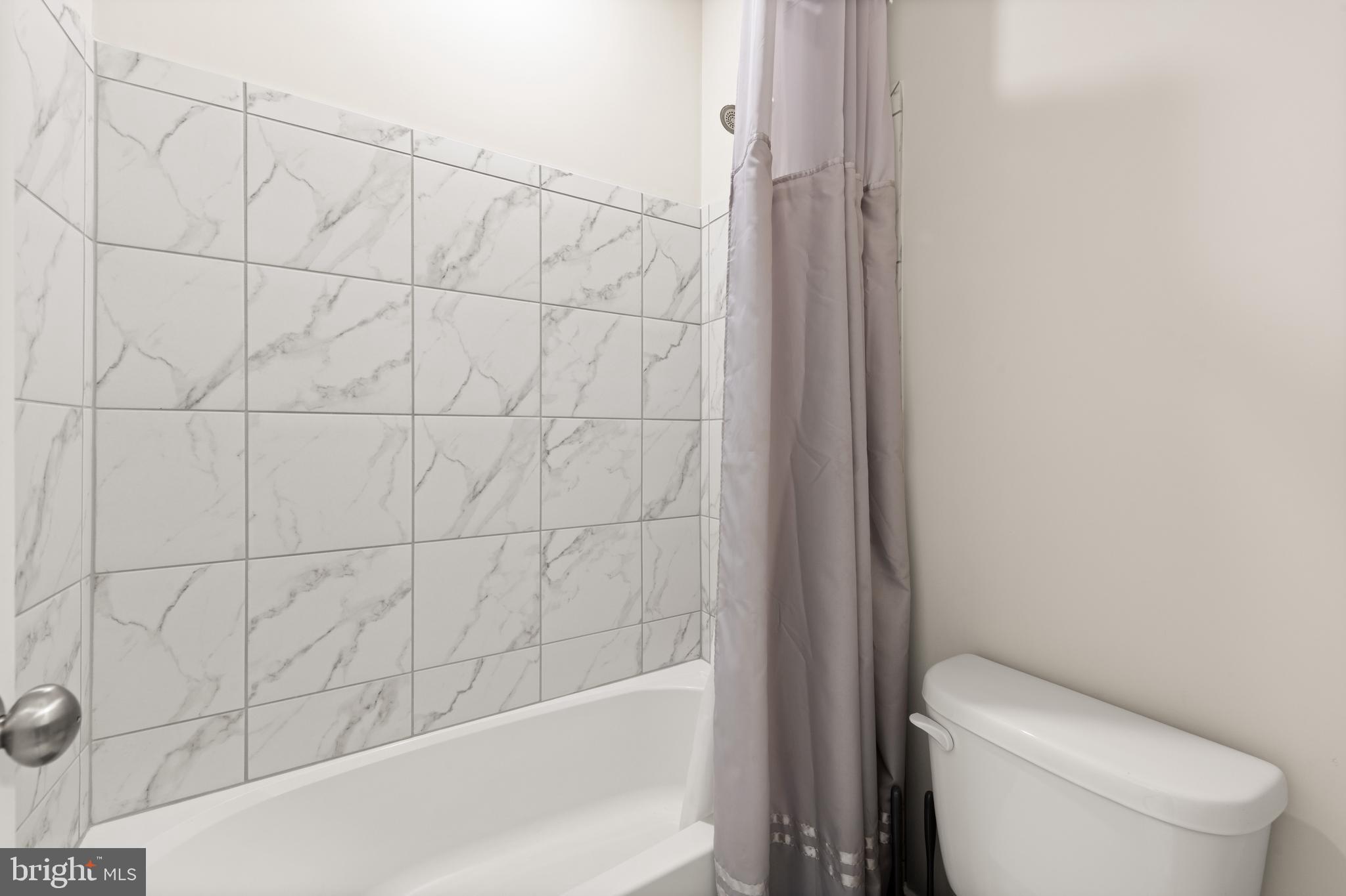 135 Klee Alley Silver Spring, MD 20906 - Photo 29 of 37 a white toilet sitting next to a bath tub