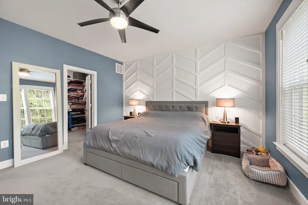 a view of walk in closet with clothes