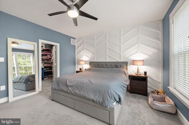 a view of walk in closet with clothes