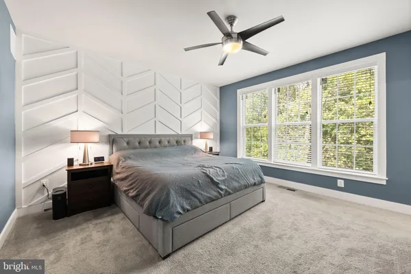 a bathroom with a double vanity sink toilet mirror and shower
