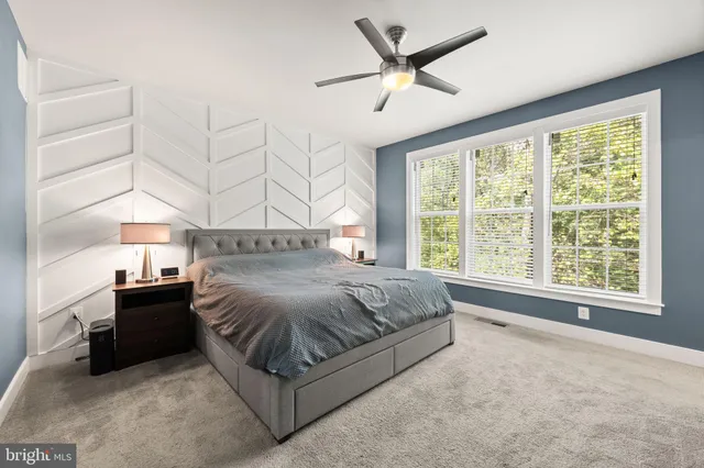 a bathroom with a double vanity sink toilet mirror and shower