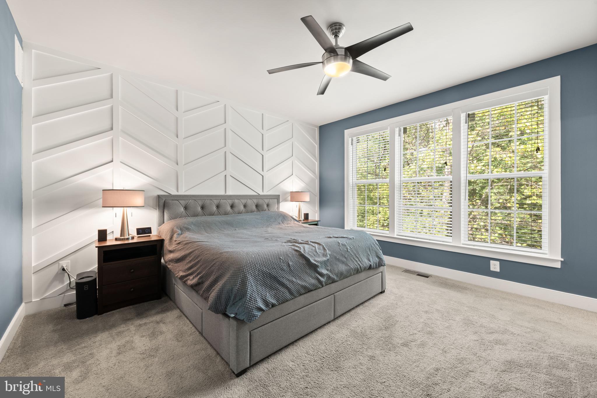 135 Klee Alley Silver Spring, MD 20906 - Photo 34 of 37 a spacious bedroom with a large bed and a chandelier fan