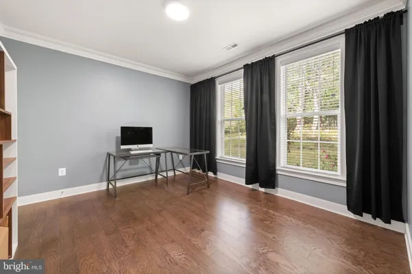 a view of a livingroom with a flat screen tv and a large window