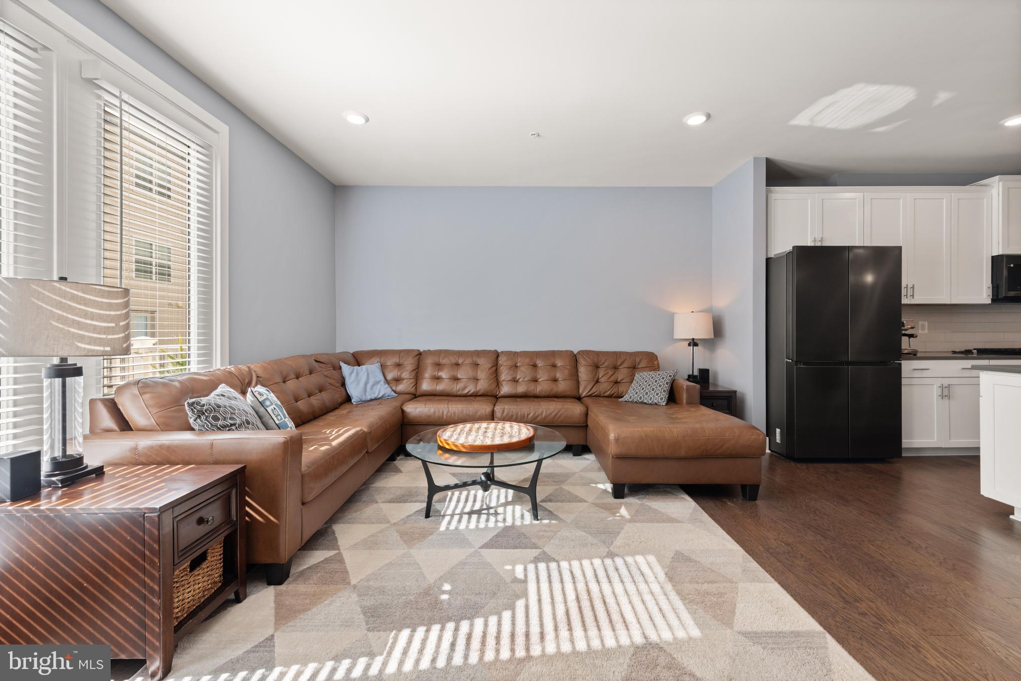 135 Klee Alley Silver Spring, MD 20906 - Photo 10 of 37 a living room with furniture a refrigerator and a table