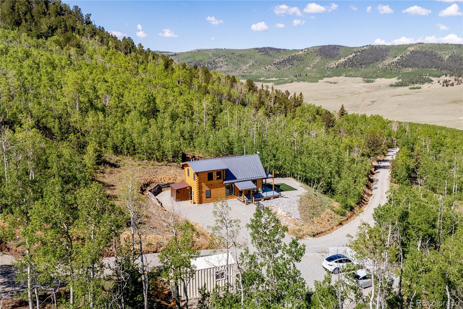 an aerial view of a house with a yard and lake view
