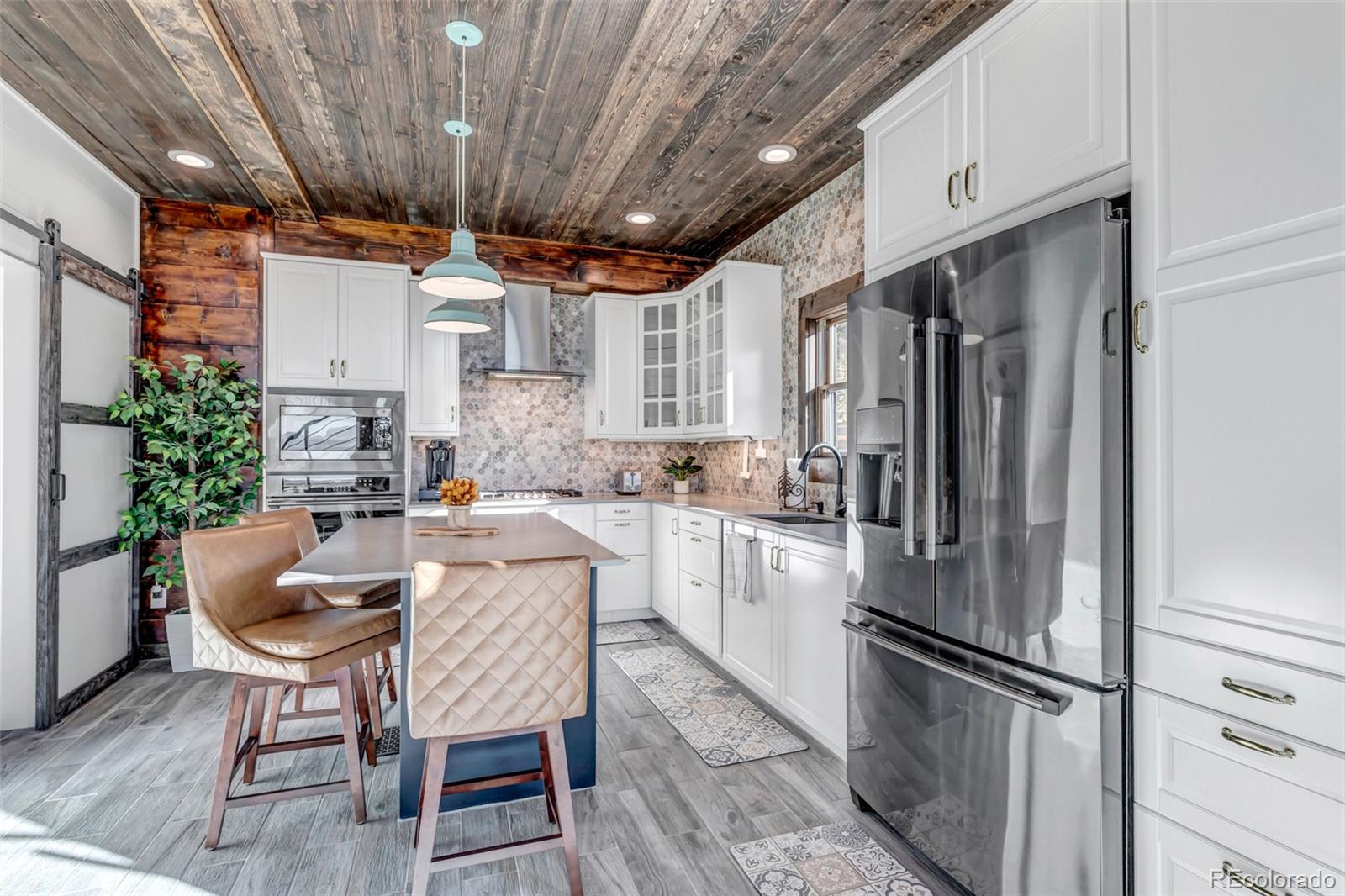 1023 Mexican Ridge Circle Como, CO 80432 - Photo 34 of 50 a kitchen with refrigerator and chairs