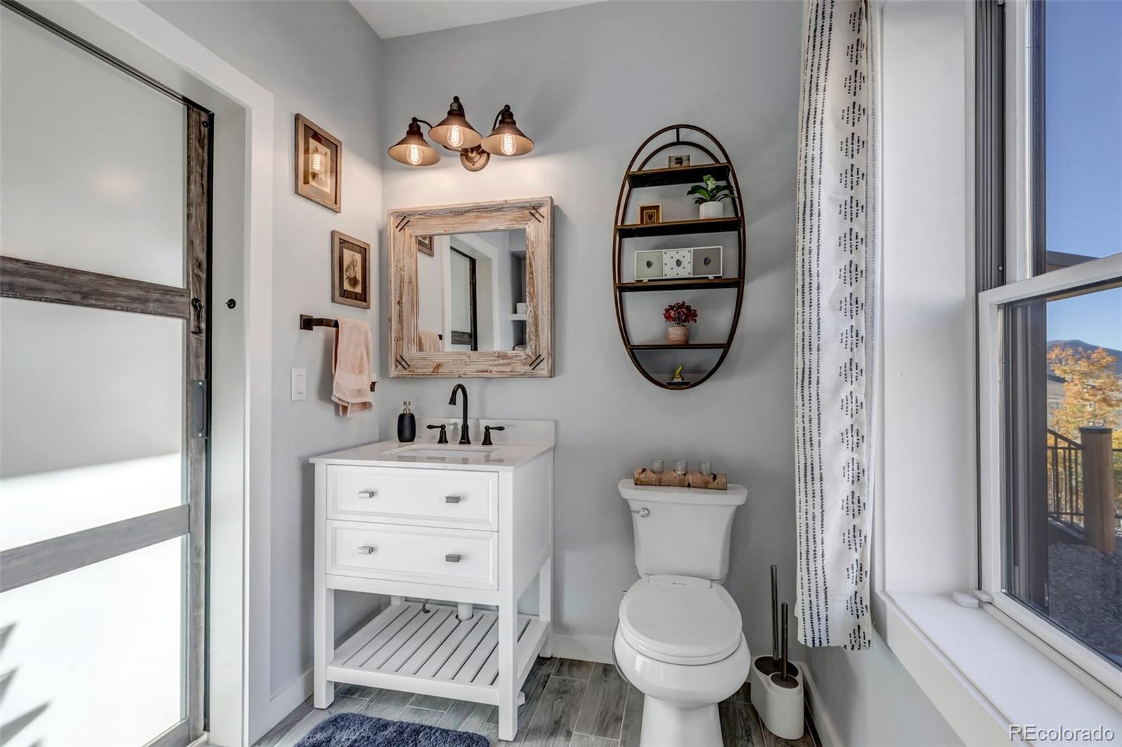 1023 Mexican Ridge Circle Como, CO 80432 - Photo 36 of 50 a bathroom with a toilet a sink and a mirror