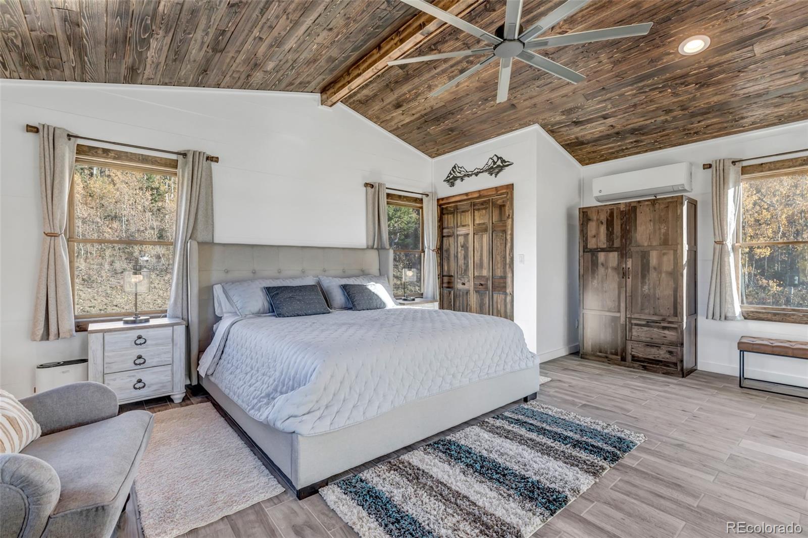 1023 Mexican Ridge Circle Como, CO 80432 - Photo 40 of 50 a spacious bedroom with a large bed and a couch