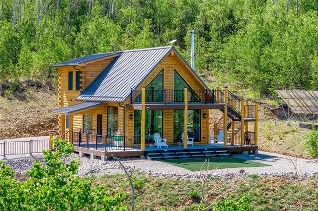 a backyard of a house with lots of green space and mountain view in back