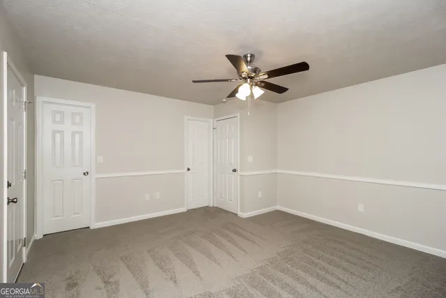 a view of a big room with closet and fan