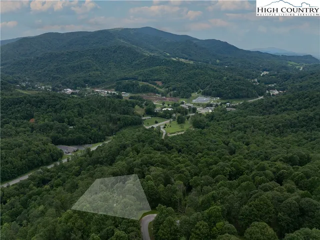 an aerial view of residential house with parking space and mountain view