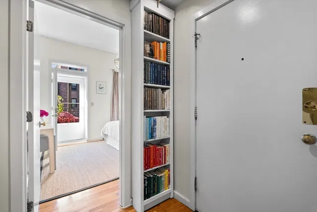 a living room with furniture and a book shelf
