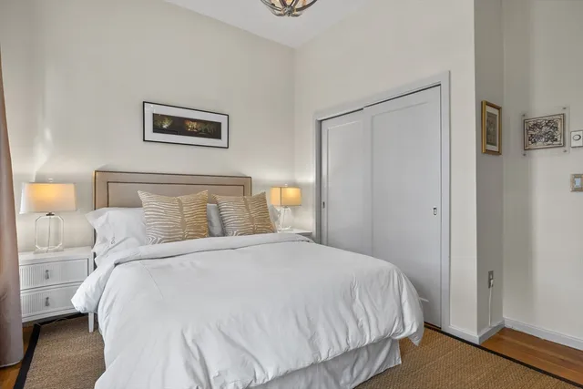 a bedroom with a bed and night stand