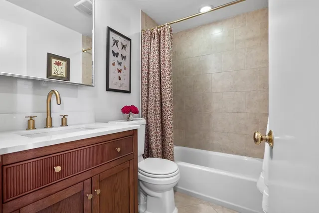 a bathroom with a sink vanity mirror and toilet