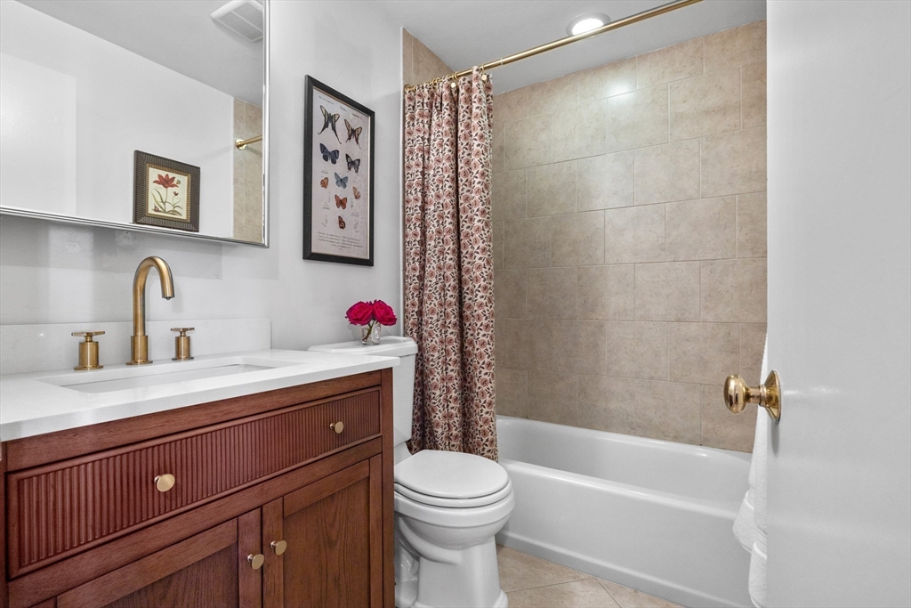 88 Worcester Street, Unit 4 Boston, MA 02118 - Photo 17 of 24 a bathroom with a sink vanity mirror and toilet